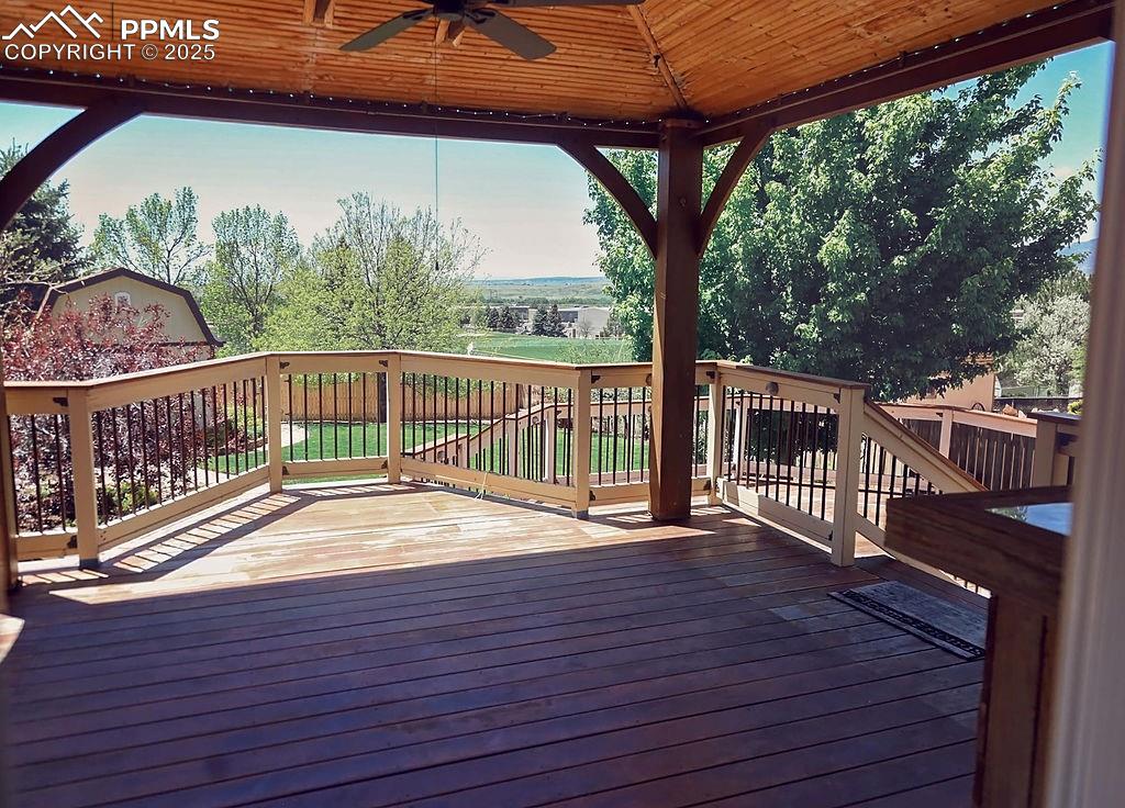 Image 36 of 50: Upper Level, Covered Deck w/ Ceiling Fan (from Kitchen Walk-Out)