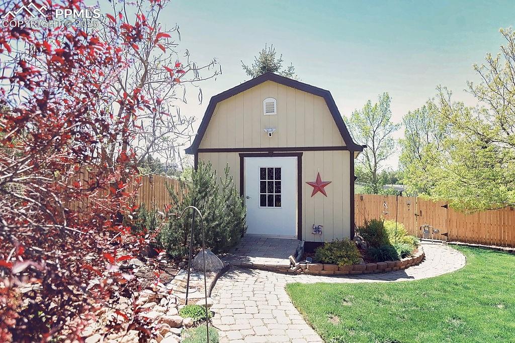 Image 40 of 50: Insulated Sunset Shed in Backyard with Electrical, a Ceiling Fan & a Loft A