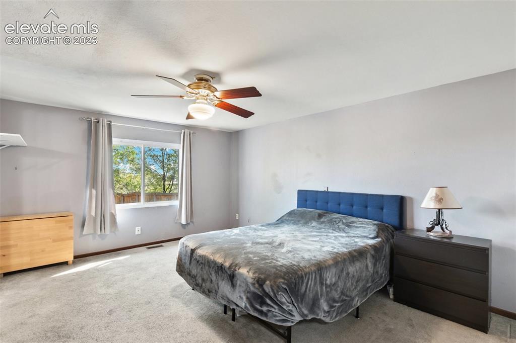 Image 25 of 27: Wall-to-wall carpeting and a ceiling fan with integrated lighting