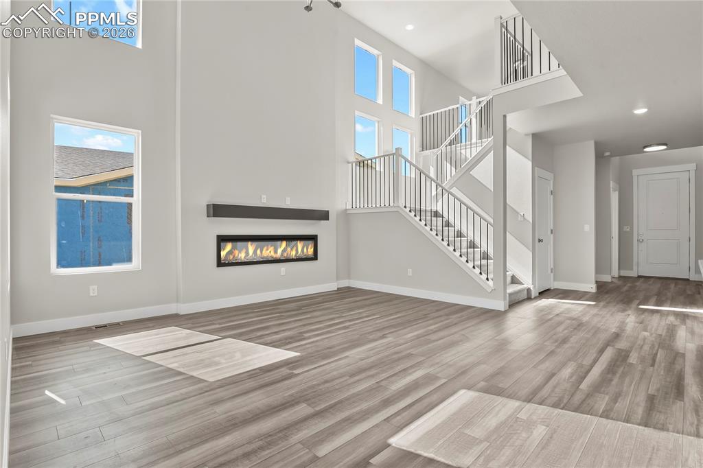 Image 4 of 43: Welcoming great room with an electric fireplace