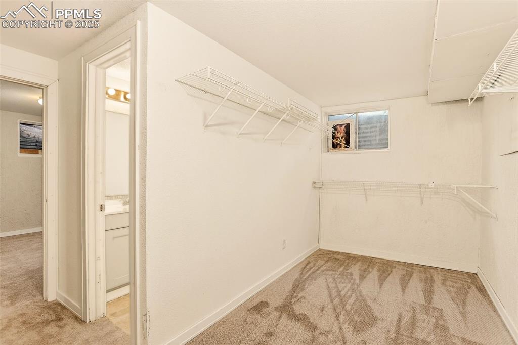 Image 25 of 37: Basement bedroom closet with new carpet
