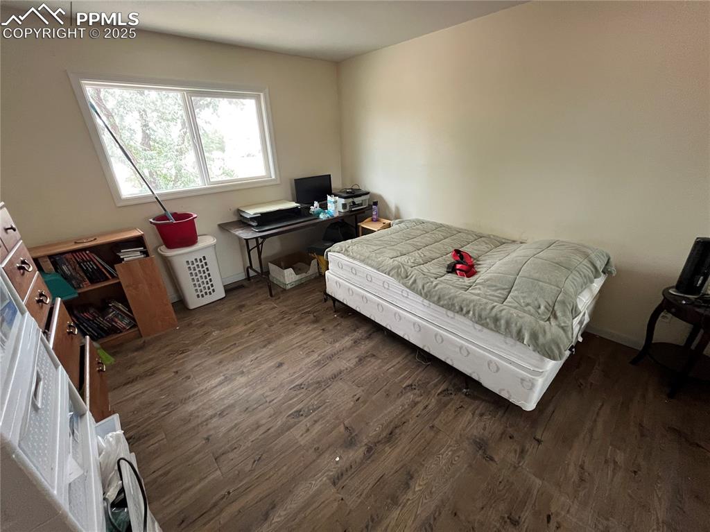 Image 11 of 21: The Primary Bedroom boasts wood laminate flooring, double mirrored wardrobe
