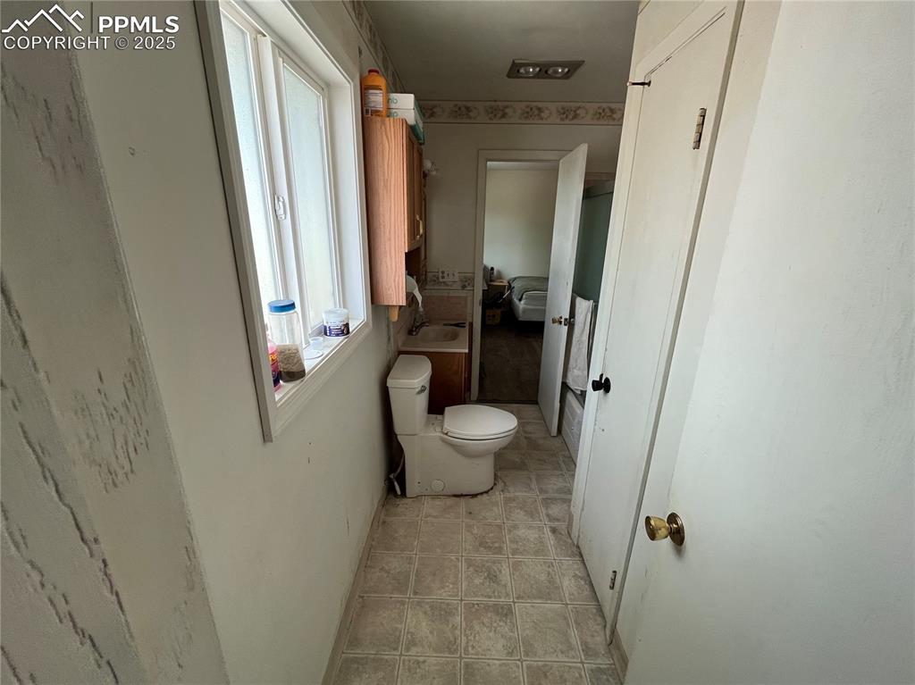 Image 13 of 21: Primary Full Bathroom with vinyl floor.