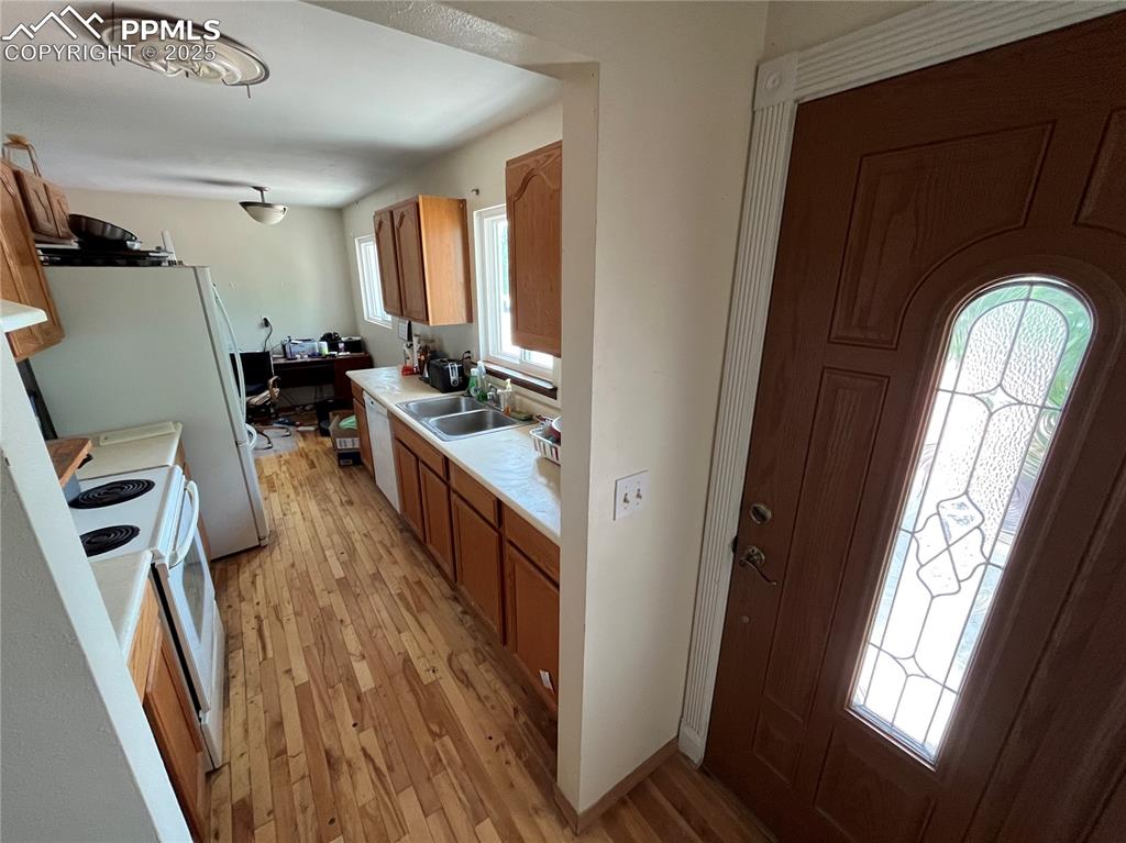Image 7 of 21: Front Entry with wood floor into the Galley Kitchen.