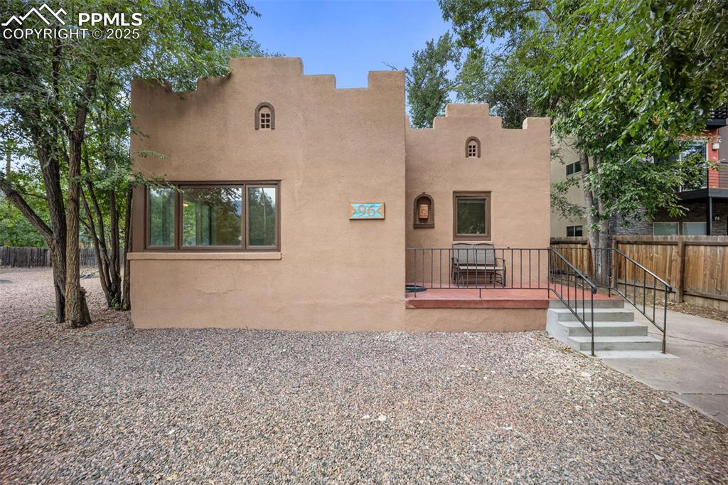 Image 2 of 31: Pueblo-style house with stucco siding