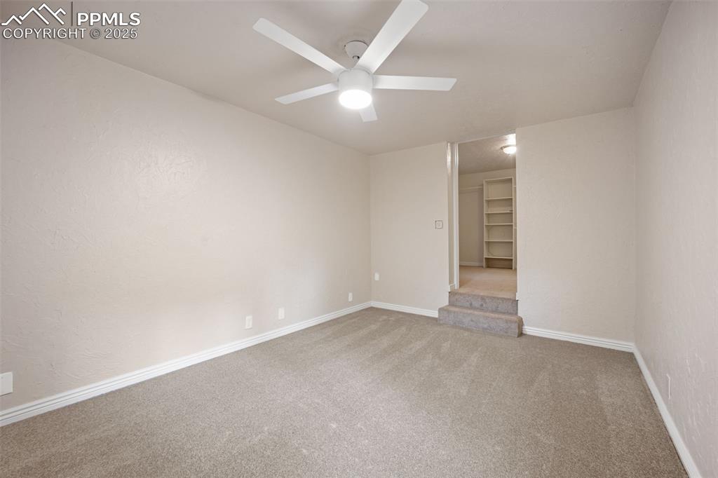 Image 26 of 31: Spare room with carpet floors and a ceiling fan