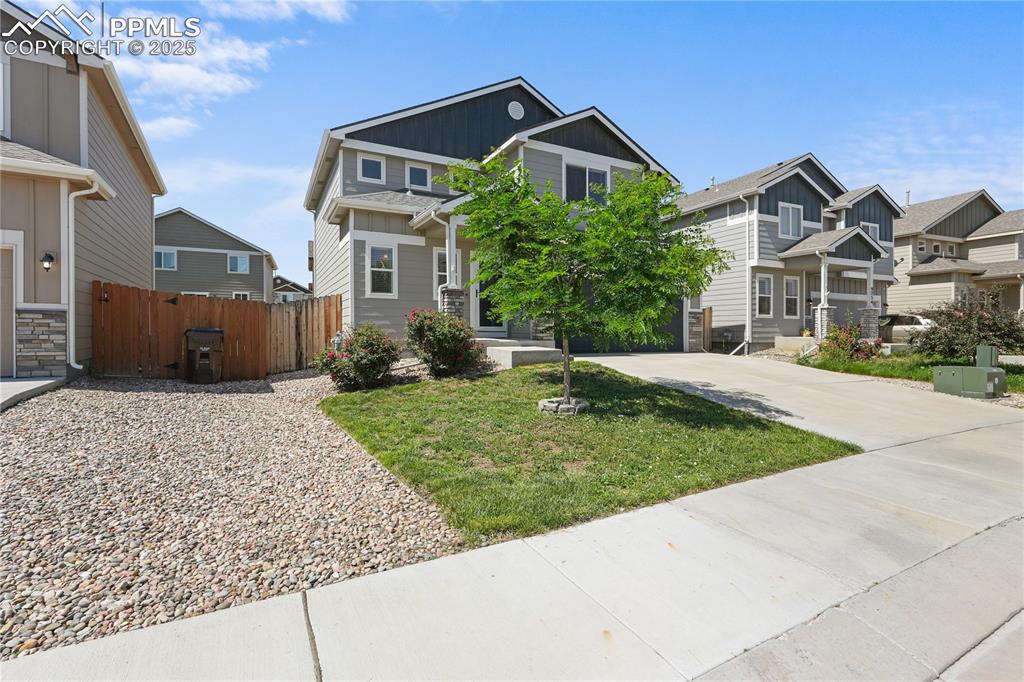 Image 3 of 22: View of front of home with a residential view, driveway, and board and batt