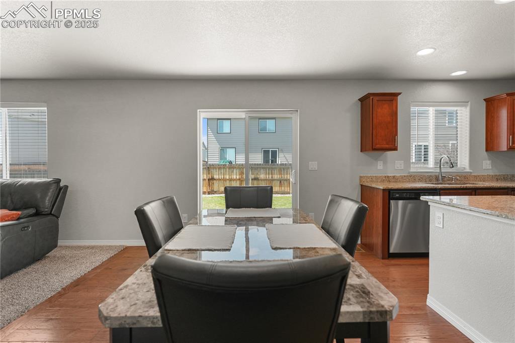 Image 9 of 22: Dining room featuring healthy amount of natural light, a textured ceiling,