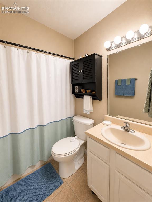 Image 14 of 27: Bathroom featuring a white toilet, light-colored vanity with an integrated 