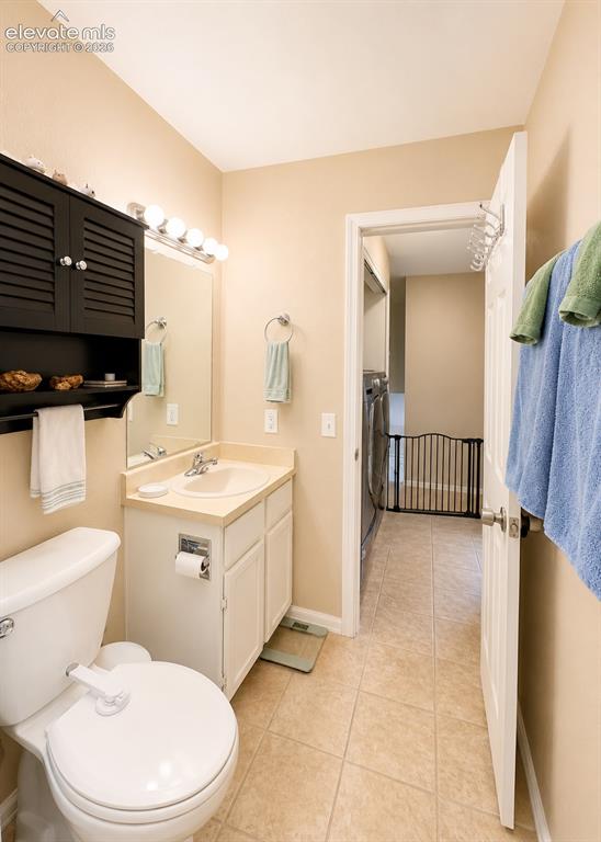 Image 16 of 27: Bathroom featuring a single vanity with storage cabinetry, an integrated si