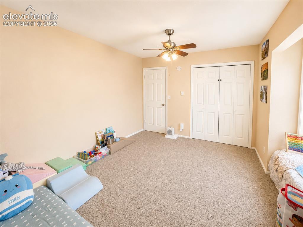 Image 20 of 27: Carpeted interior space featuring a ceiling fan with integrated lighting, a