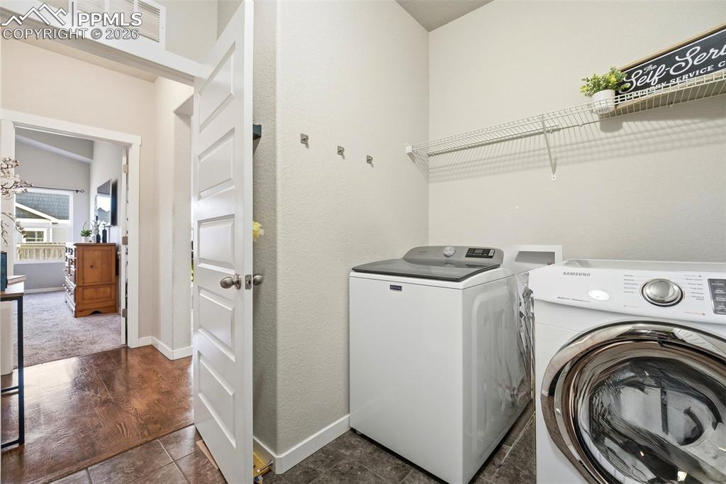 Image 28 of 50: Laundry room featuring baseboards and separate washer and dryer