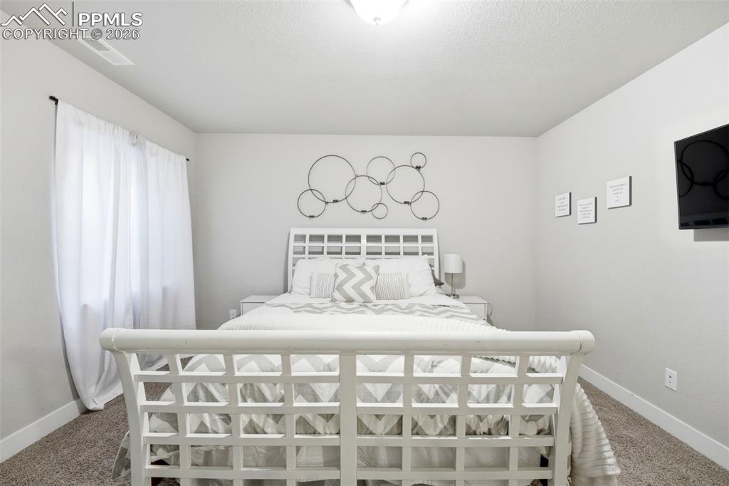 Image 39 of 50: Bedroom with baseboards and carpet