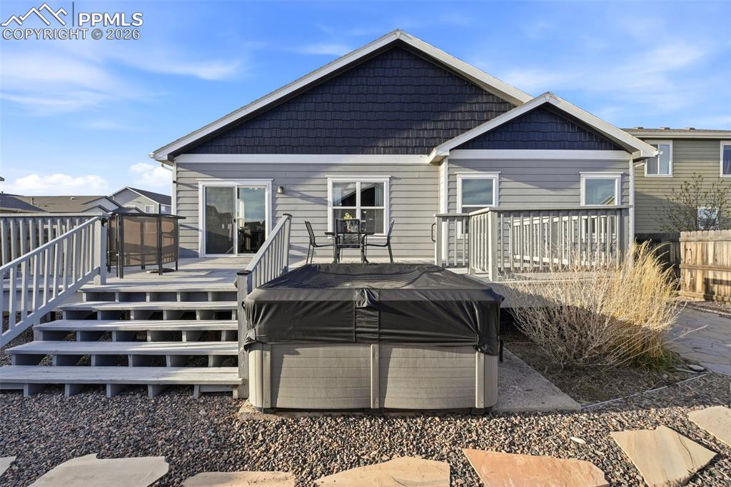 Image 41 of 50: Rear view of house featuring a wooden deck