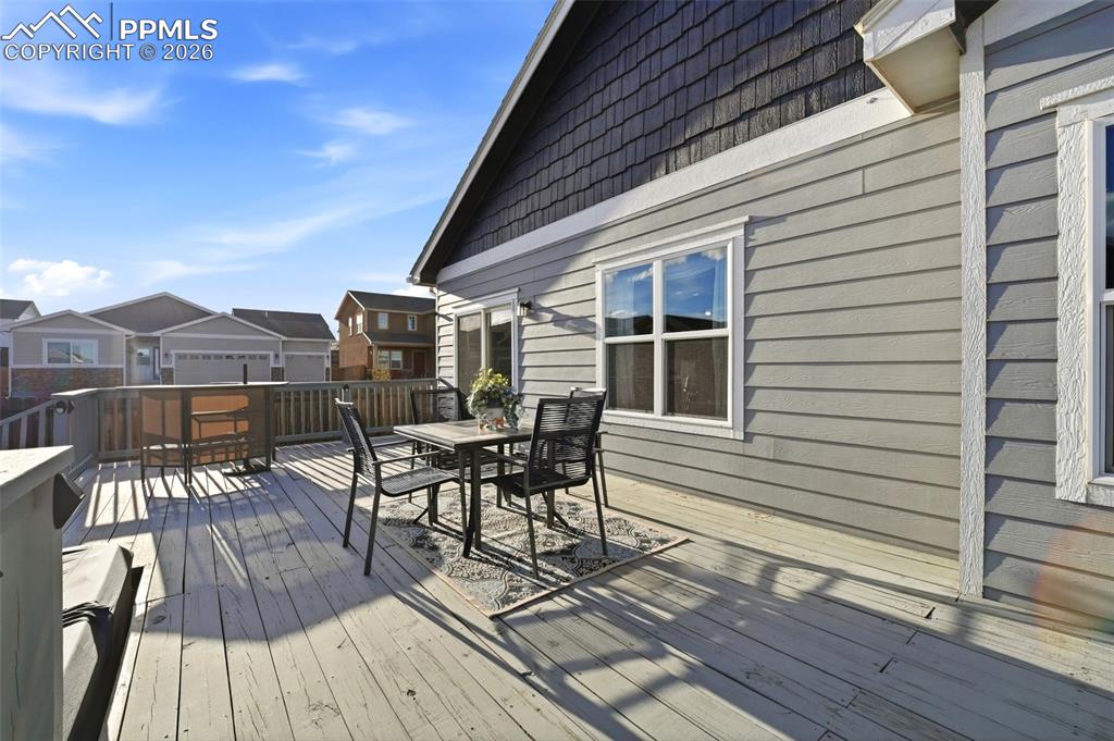 Image 42 of 50: Deck with outdoor dining space and a residential view