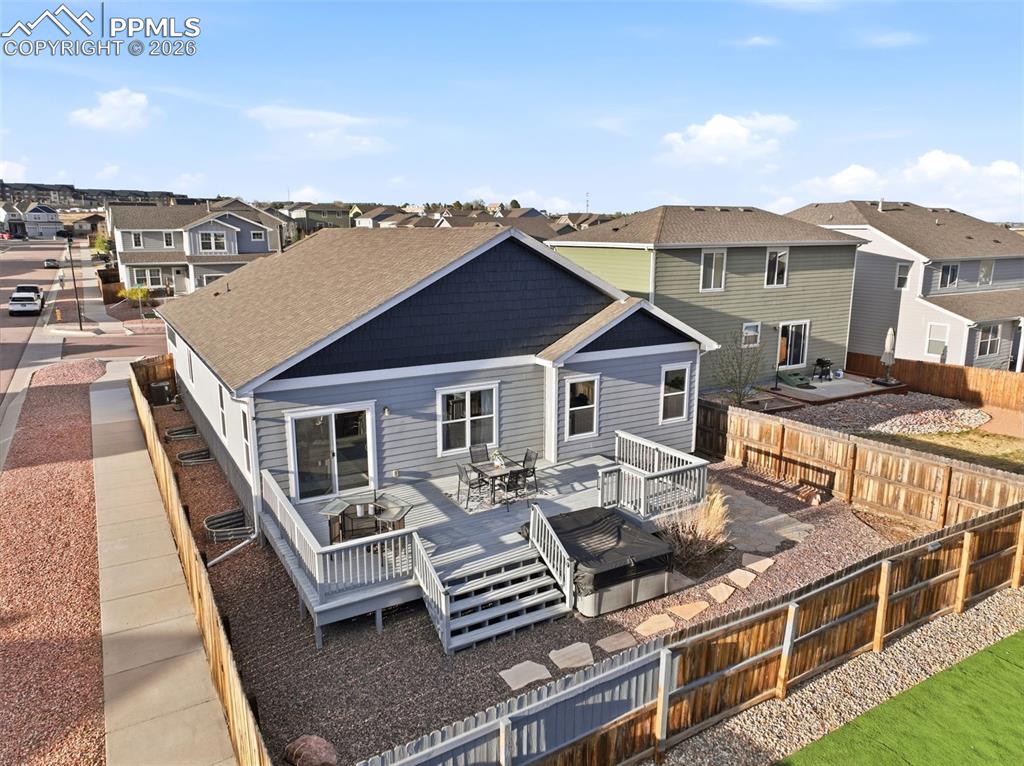 Image 48 of 50: Rear view of house featuring a residential view, a deck, outdoor dining are