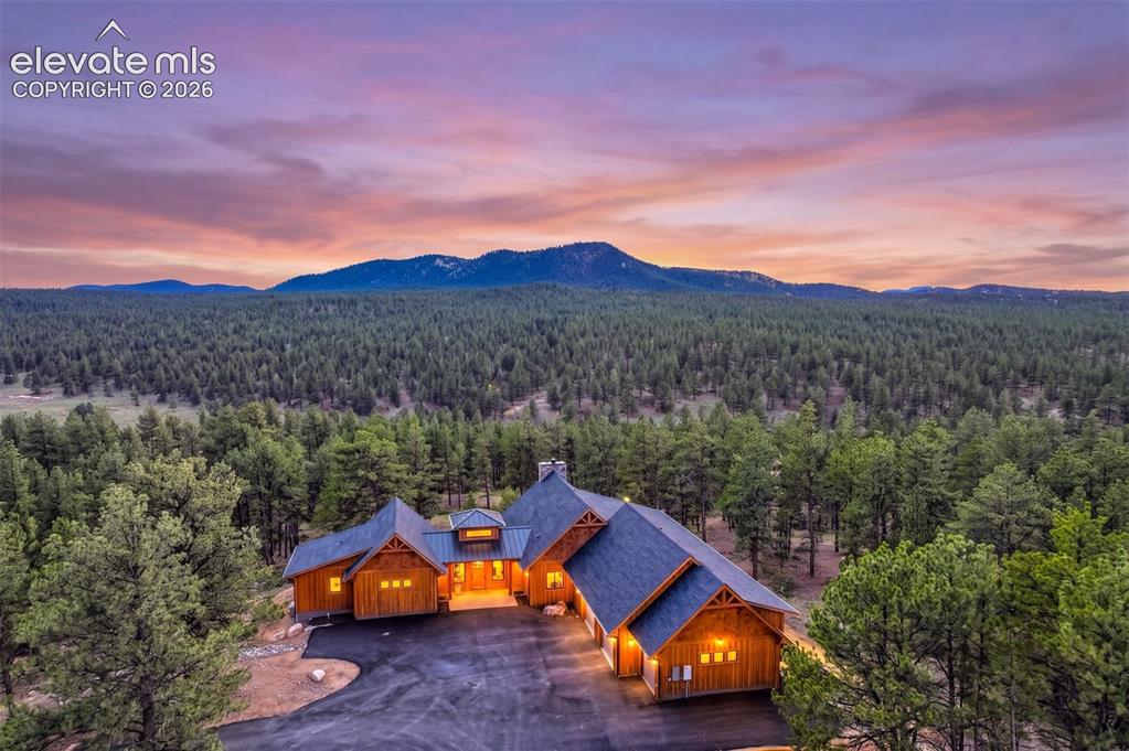 Image 1 of 50: Expansive natural landscape with dense forest and distant mountains