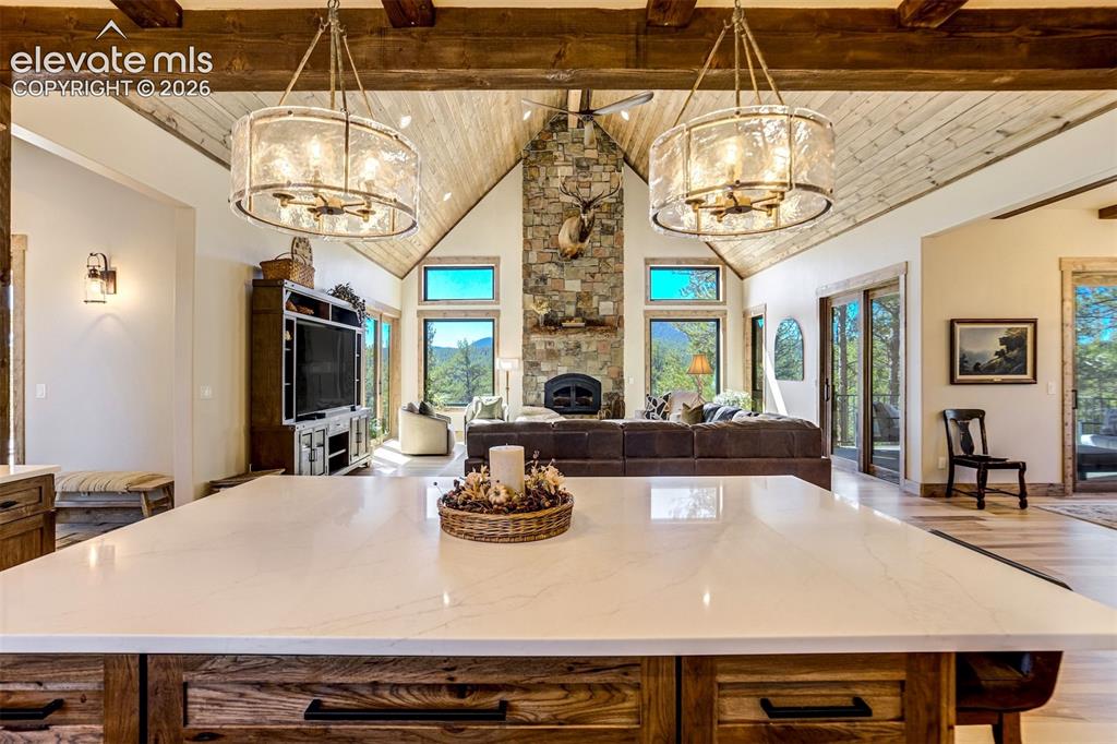 Image 10 of 50: Spacious open-concept interior featuring a vaulted wood-finish ceiling with