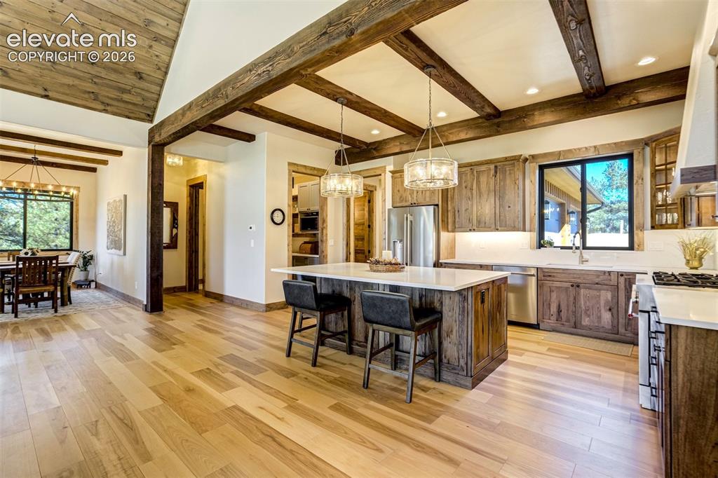 Image 5 of 50: Vaulted wood-paneled ceiling with exposed beams, wood-finish flooring, cust