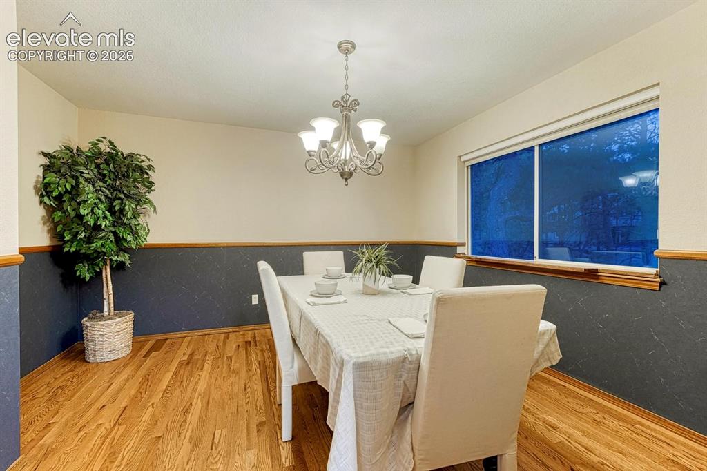 Image 15 of 46: Formal dining with hardwood and chair rail