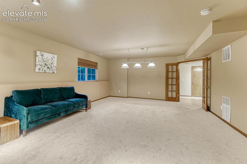 Image 30 of 46: Large family room with pool table lights