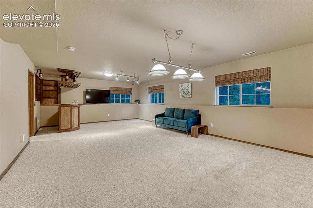 Image 31 of 46: large family room with TV included