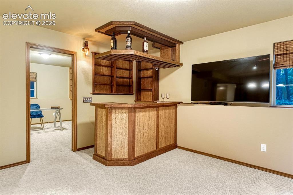 Image 33 of 46: Dry bar with copper counter top