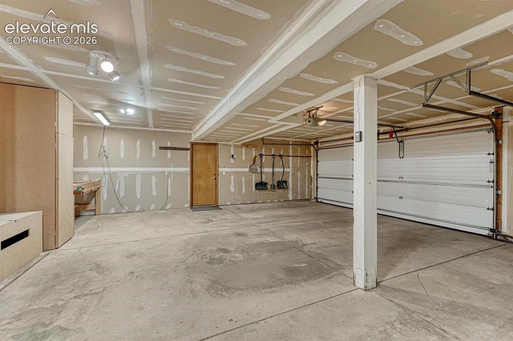 Image 35 of 46: 3 car garage with storage and workshop