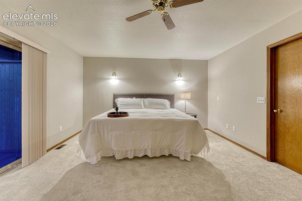 Image 6 of 46: Master bedroom with walkout to covered deck