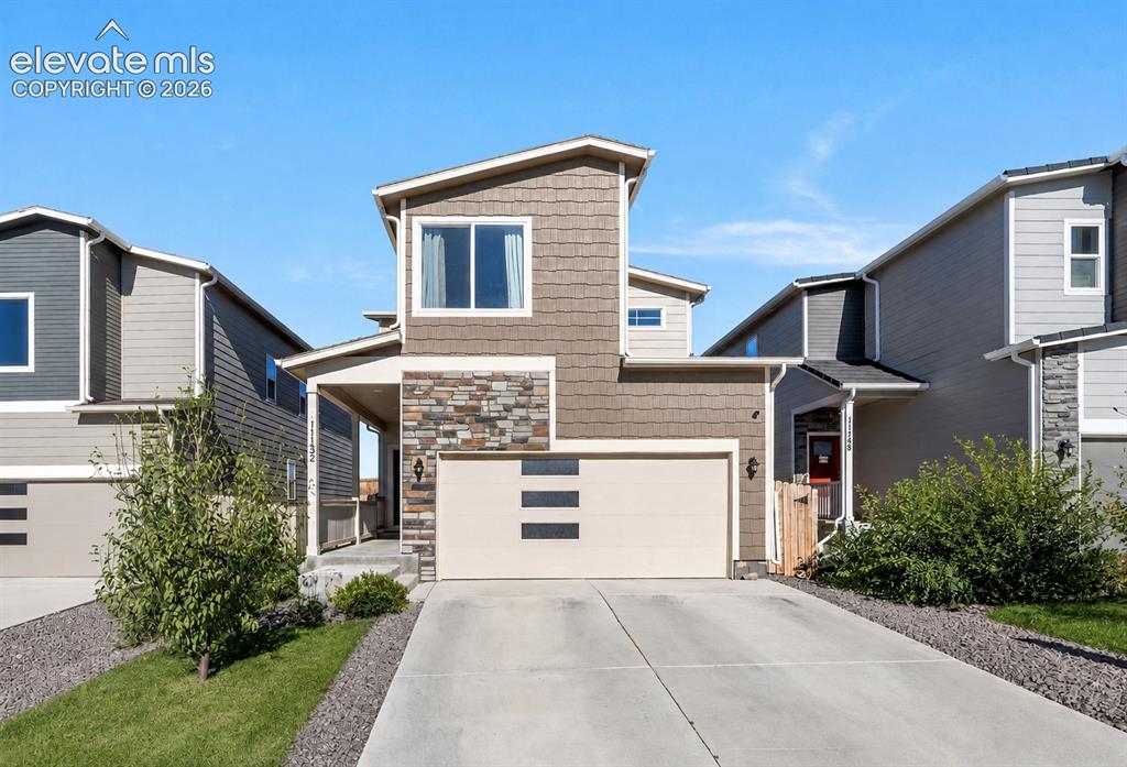 Image 1 of 21: Modern two-story home built in 2022 with attractive curb appeal and low-mai