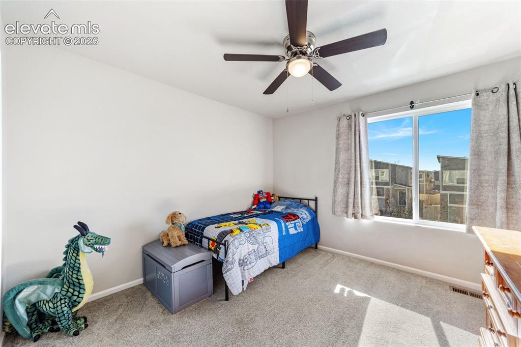 Image 12 of 21: Third bedroom with large window and natural light.