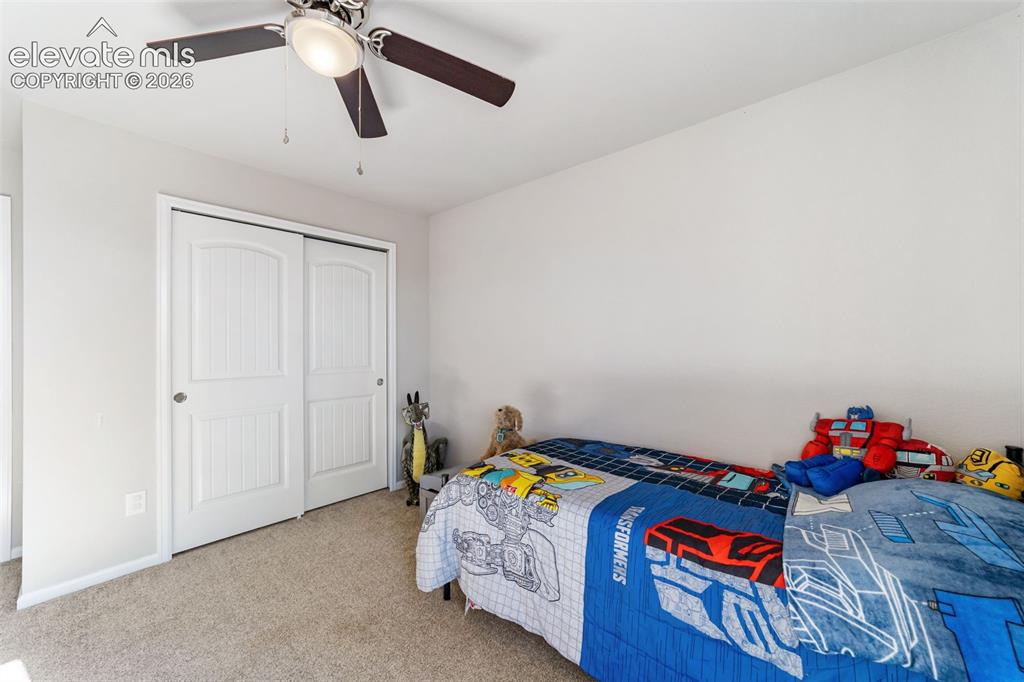 Image 13 of 21: Comfortable 3rd bedroom with closet storage and flexible use.