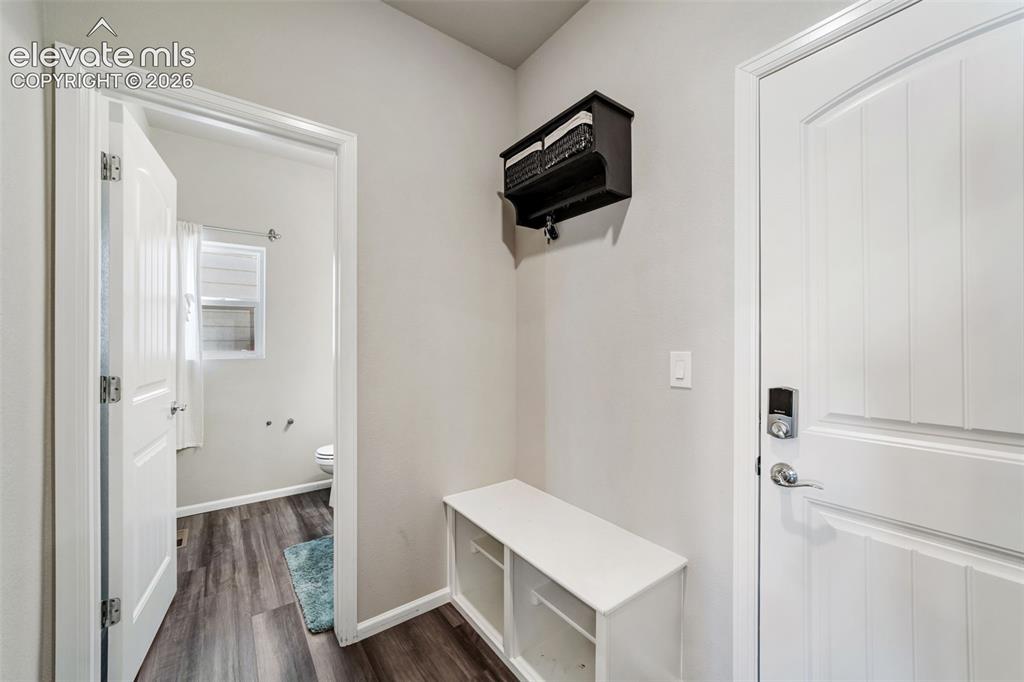Image 18 of 21: Functional mud room with built-in bench and storage area.