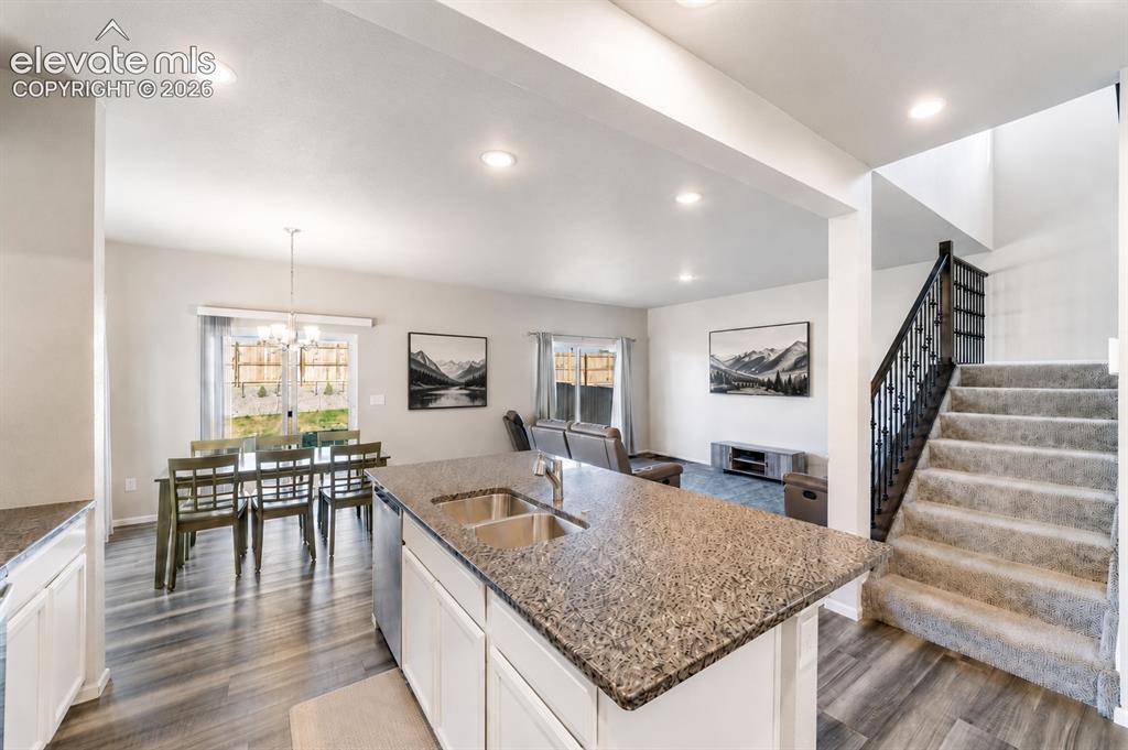 Image 2 of 21: Granite island kitchen with open-concept layout, stainless steel appliances