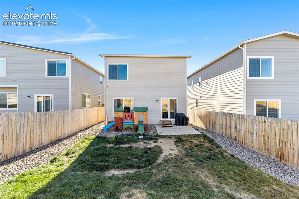 Image 21 of 21: Fully fenced backyard with patio space.