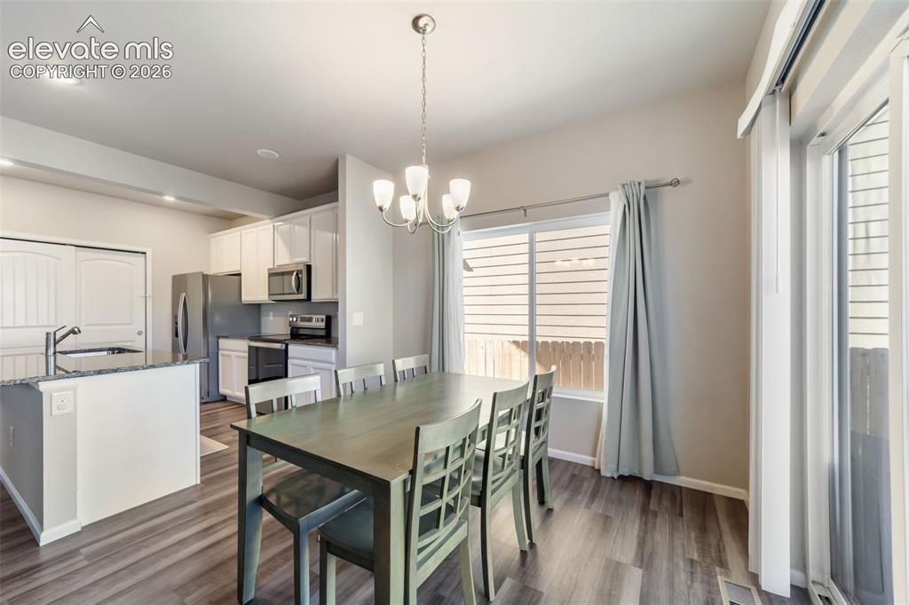 Image 6 of 21: Dining area with easy access to the kitchen and backyard.