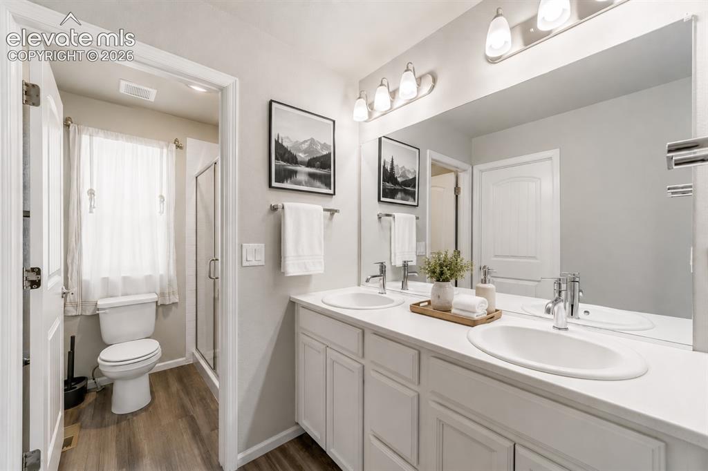 Image 8 of 21: Primary bath with dual-sink vanity and ample counter space.