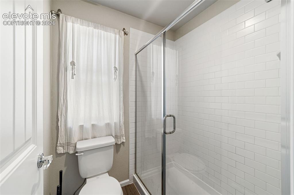 Image 9 of 21: Primary bath featuring a walk-in shower and natural light.