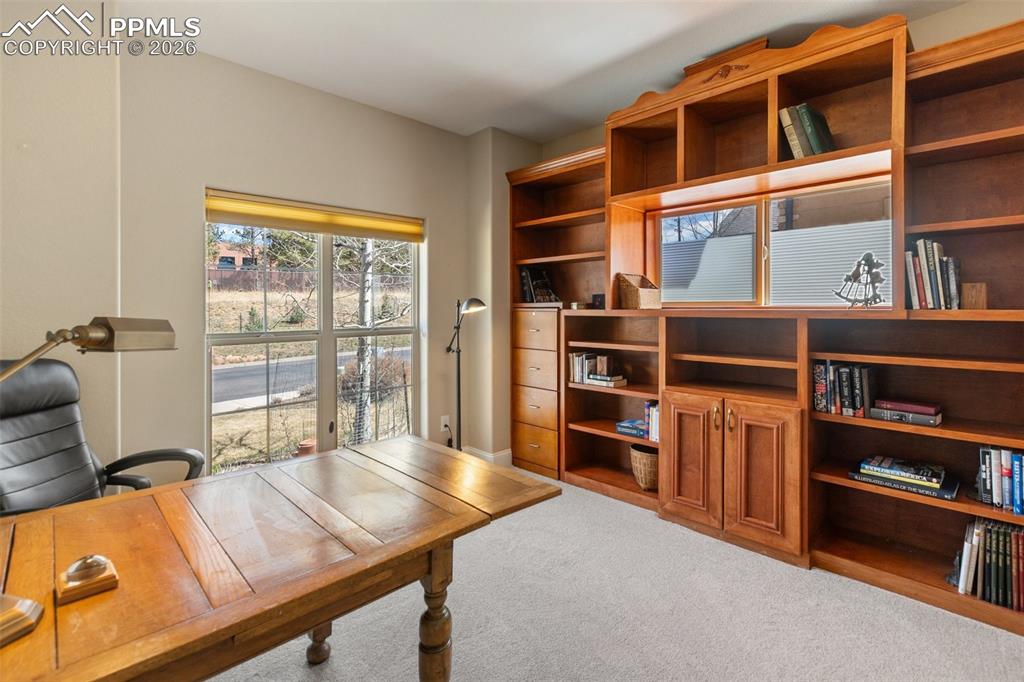 Image 16 of 39: Office with built in book shelves.