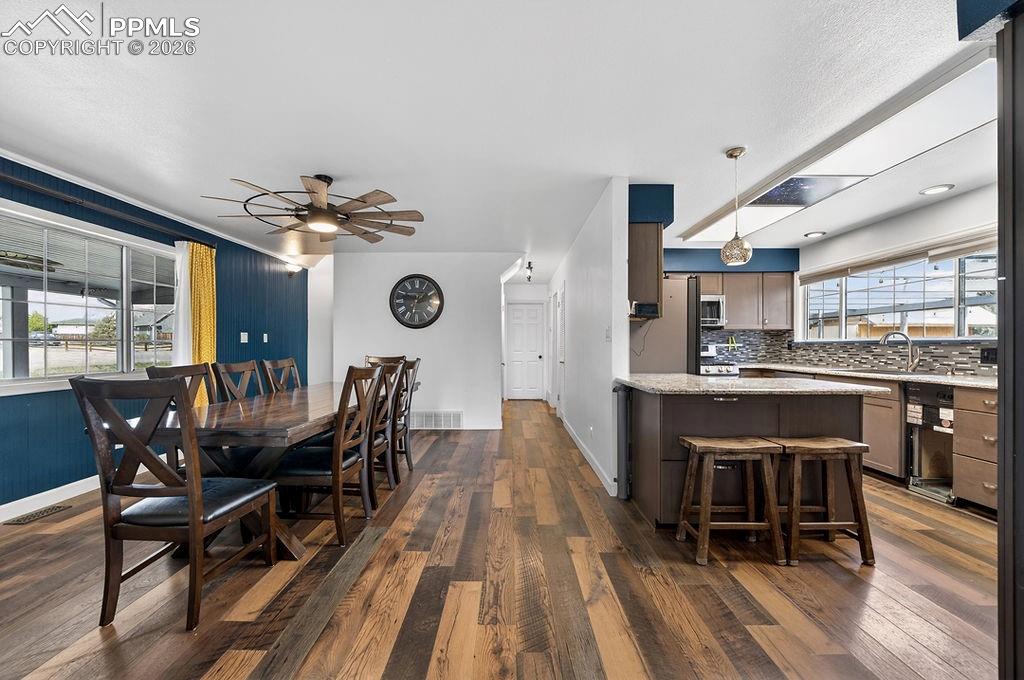 Image 13 of 46: View of dining and kitchen from living room.