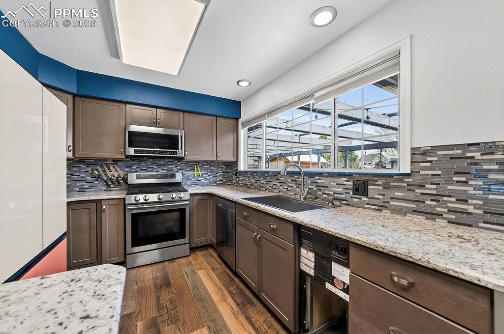 Image 16 of 46: Trash compactor is in place and fully functional; the cover was removed dur