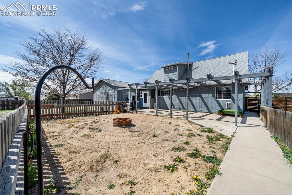 Image 35 of 46: Fire pit area, (once an area for an above ground swimming pool).
