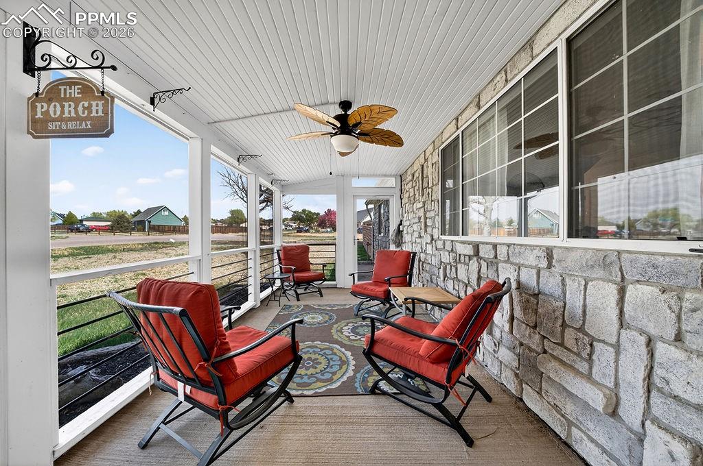 Image 5 of 46: Screened in front porch with concrete floor.