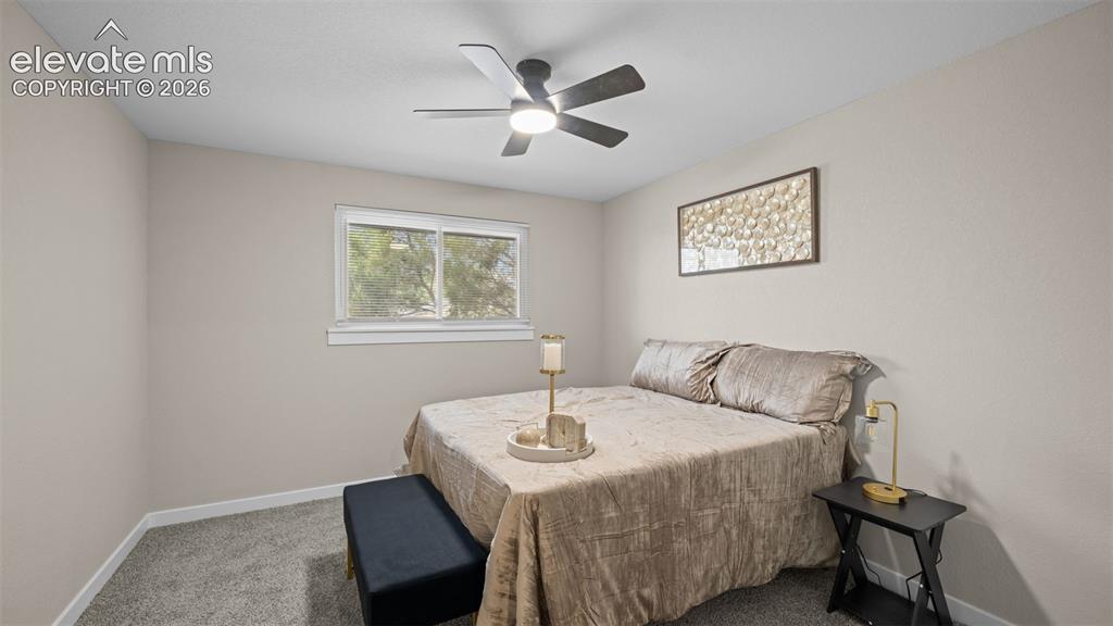 Image 16 of 45: Bedroom featuring a ceiling fan with integrated lighting, a window with whi