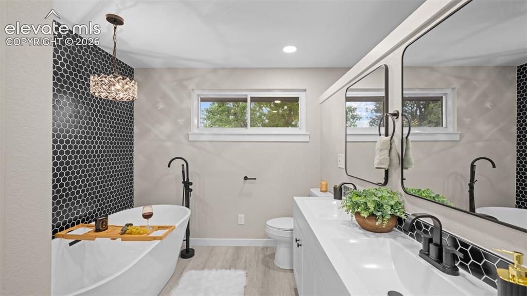 Image 20 of 45: Freestanding soaking tub with a floor-mounted matte black faucet, set again