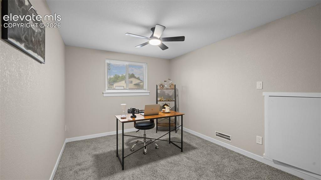 Image 23 of 45: Carpeted room featuring a ceiling fan with integrated lighting, a window wi