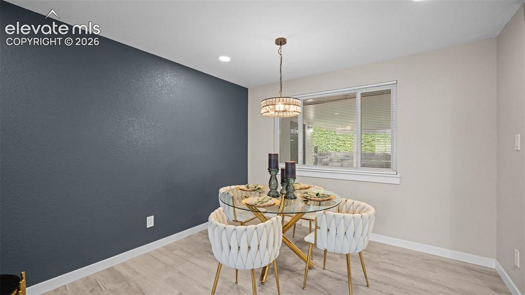 Image 8 of 45: Recessed lighting illuminates the space, complementing the central chandeli