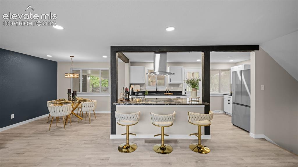 Image 9 of 45: Open-concept interior featuring light wood-finish flooring, recessed lighti