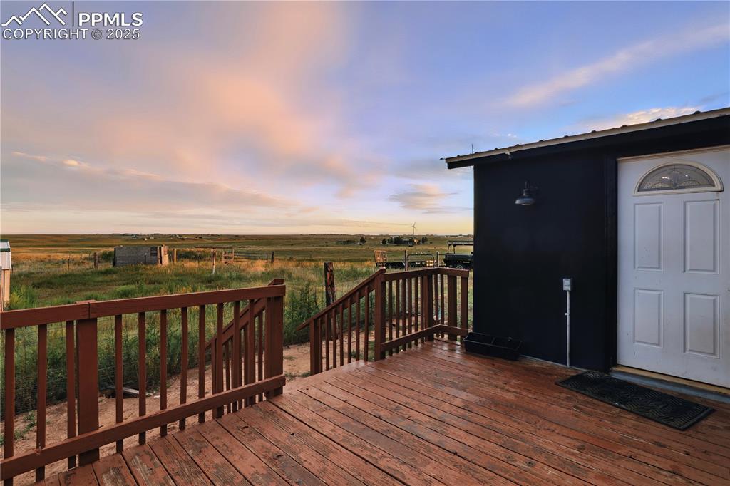 Image 10 of 50: Back deck - right off of the kitchen! Perfect for summer BBQs!