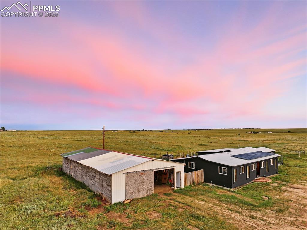 Image 2 of 50: Aerial view including the home with a covered front porch and oversized bar
